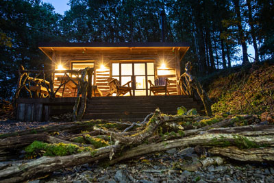 Log cabin beautifully lit up at night